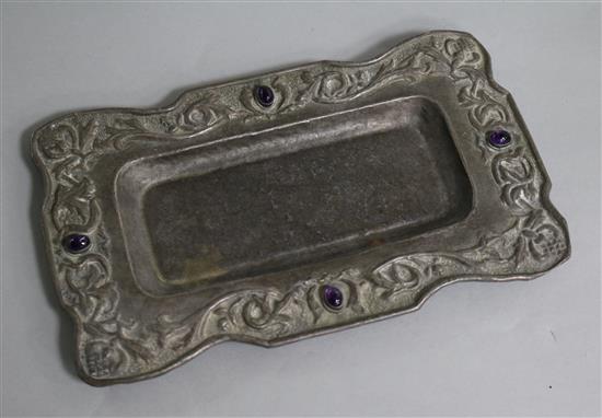 An early 20th century Arts & Crafts repousse white metal and cabochon amethyst set rectangular stand, 22.1cm.